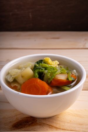 A bowl of soup with vegetables in it