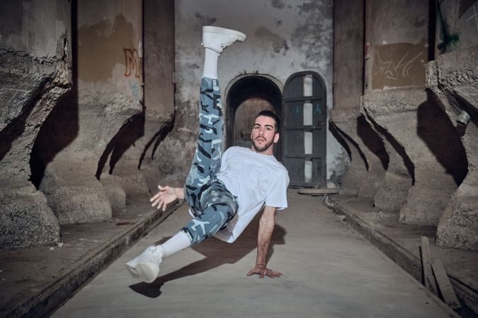 Active man break dancing in abandoned building