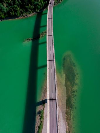Drone image with the bridge over Sylvenstein Lake in bright light, on a sunny day in summer