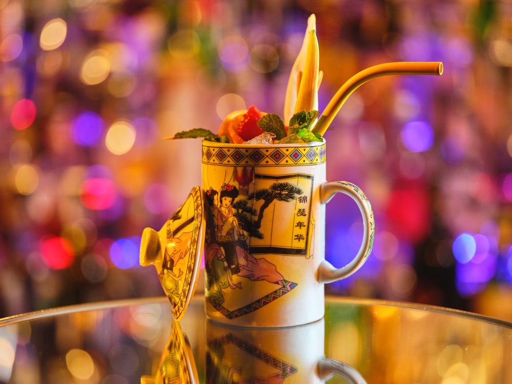 Exotic cocktail in porcelain cup served on table