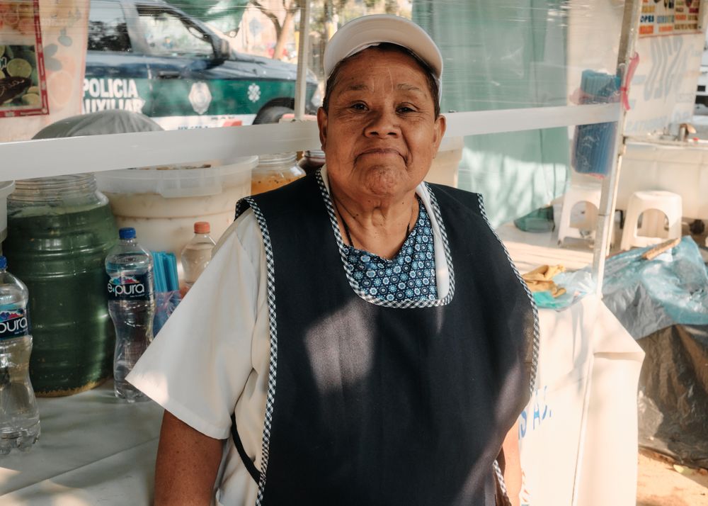 Woman in apron in food stalll