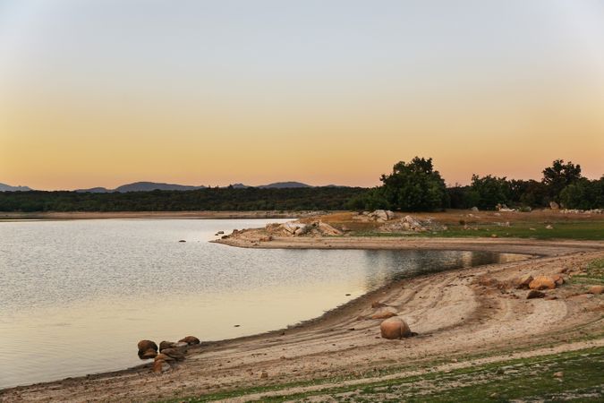 Picturesque view of lake with countryside route, fir forest and hills in Valmayor lake Spain
