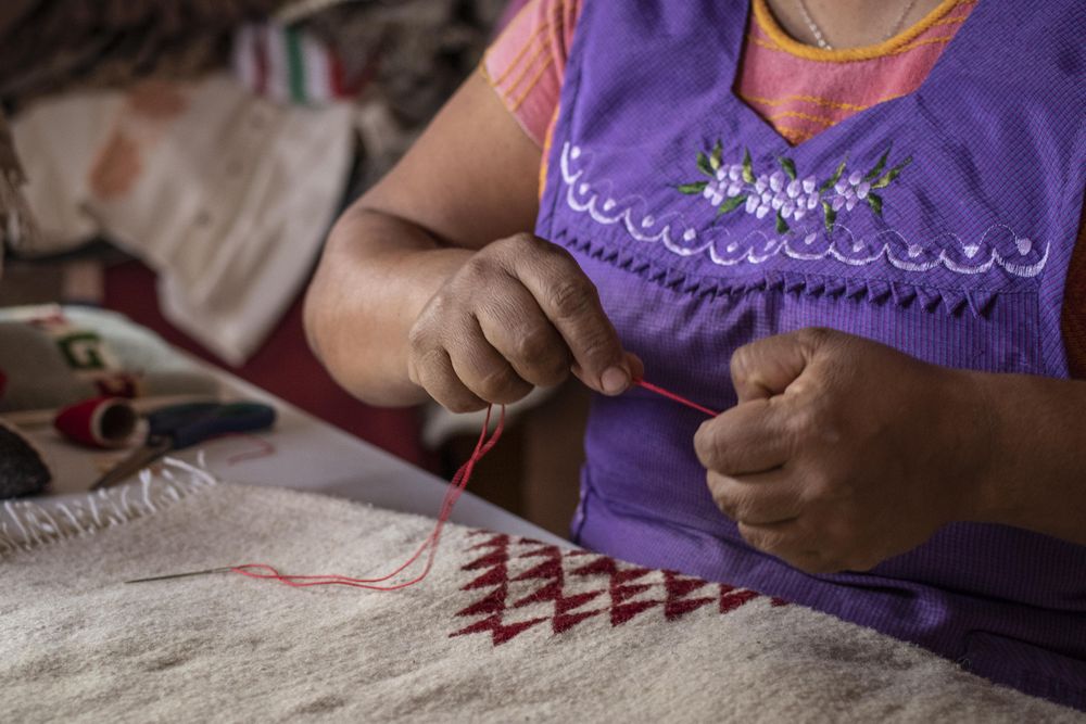 Close-up shot of woman holding red thread