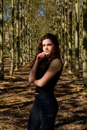 Fit teenage girl standing in forest