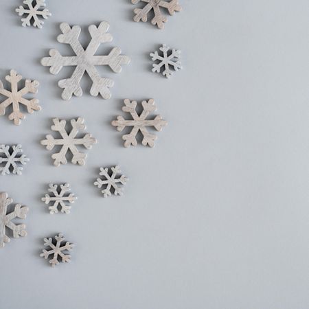 Grey snowflake decorations on grey background