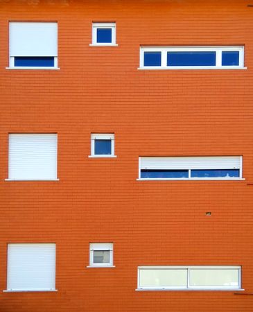 Exterior view of an orange brick building with windows