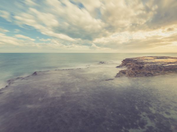 Rocky seashore under blue sky