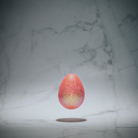 Pink glitter egg on marble background