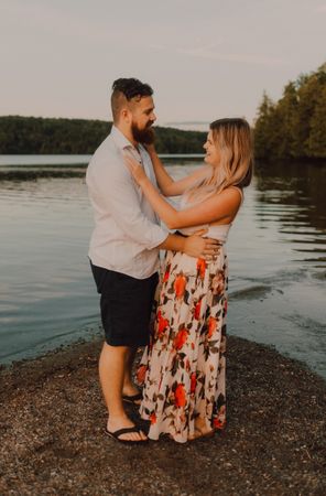Loving couple standing ankle deep in water on beach