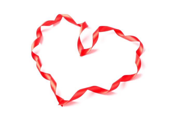 Red ribbon heart isolated on blank background