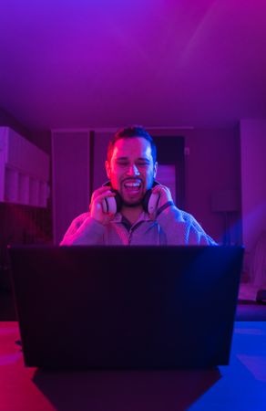 Man listening cheerfully to music with headphones.
