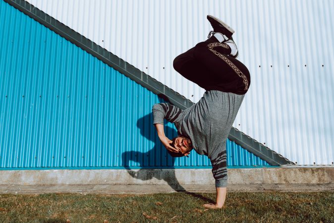 Man performing handstand near wall