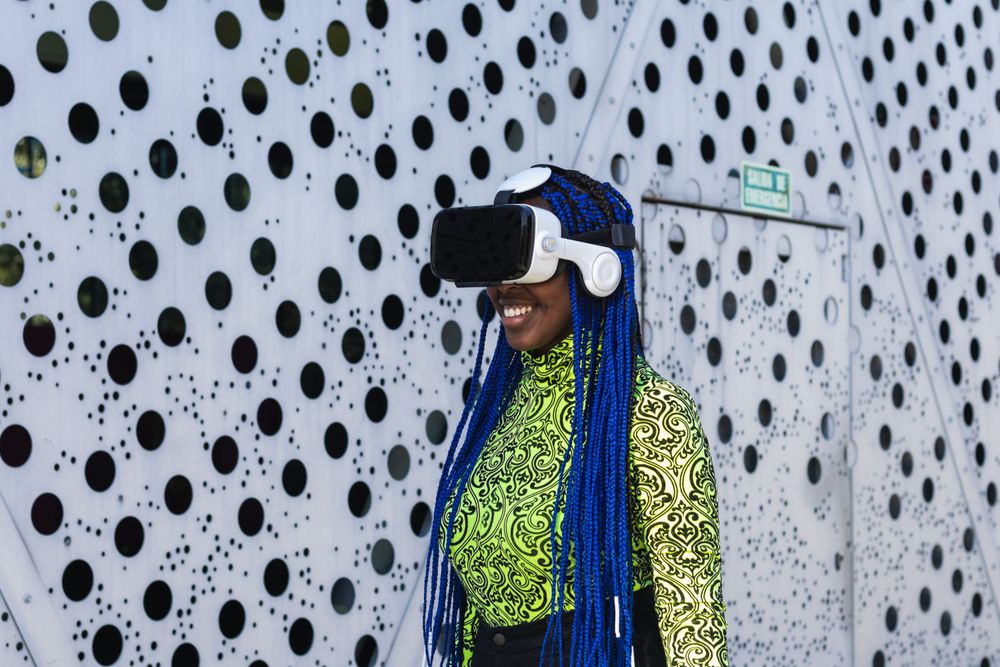 Black woman in VR headset in city