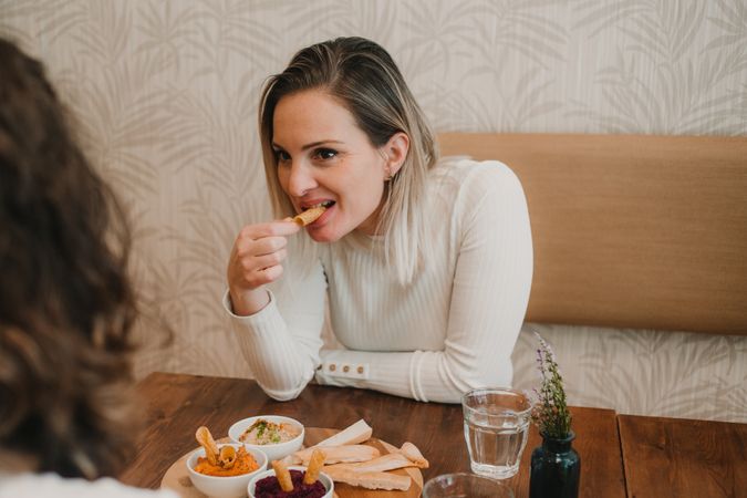 Woman smiling choosing food at table