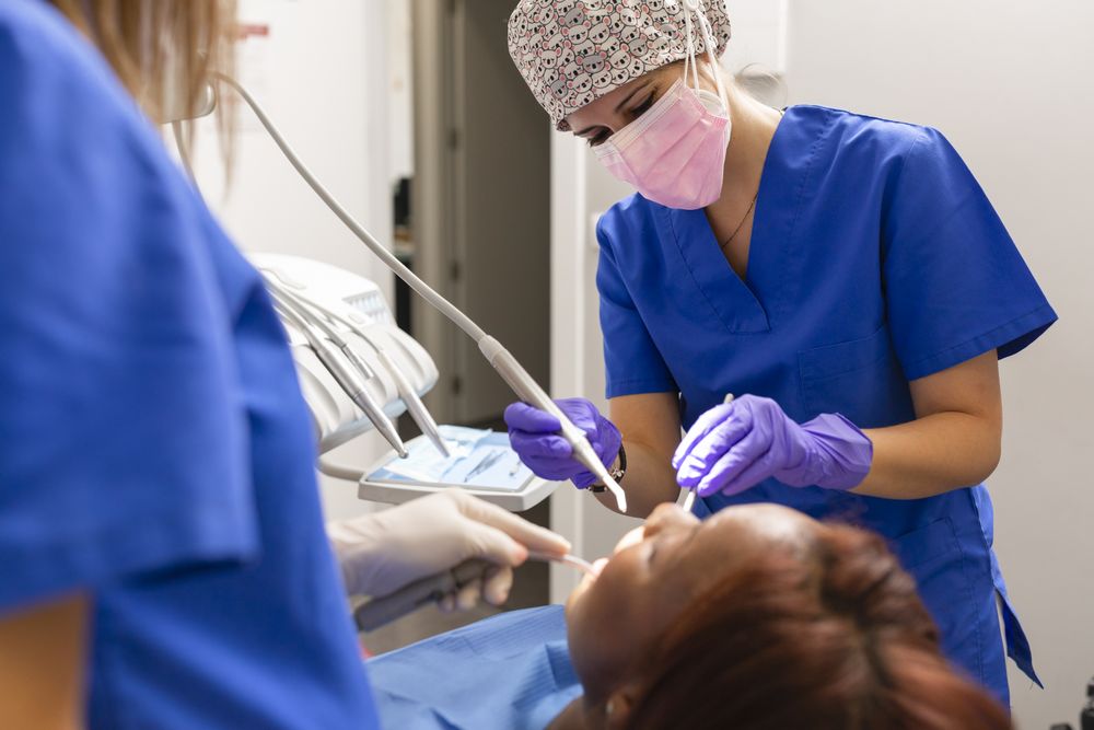Female dental patient lying back with open mouth during exam