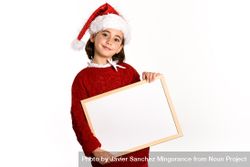 Child in Santa costume holding blank board bejOp0