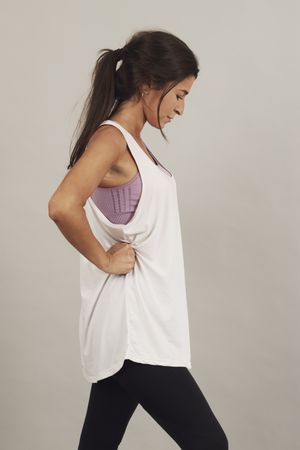 Concentrated young active female athlete exercising in studio