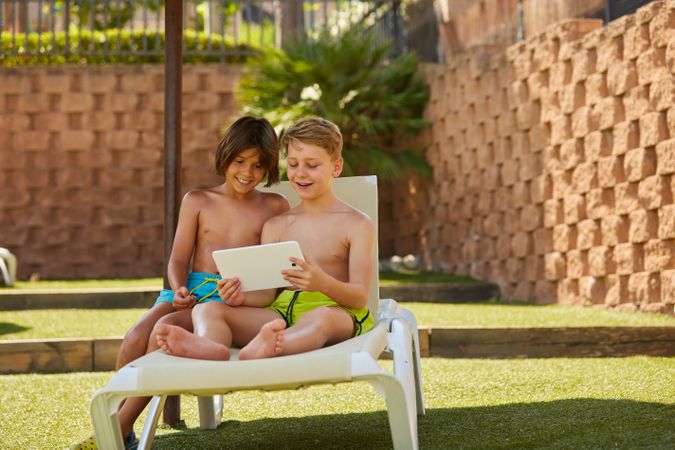 Boys using tablet in garden