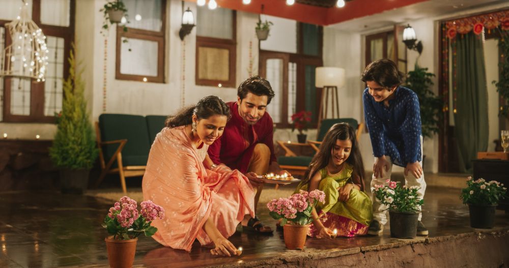 Portrait of an Indian Family Celebrating Divali by Putting Lamps in Their Backyard.
