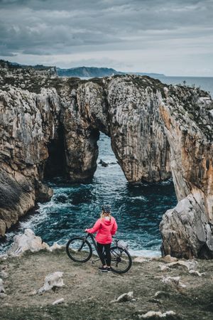 Female bicyclist on rocks