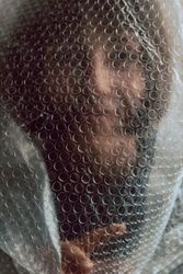 Woman entangled in bubble wrap