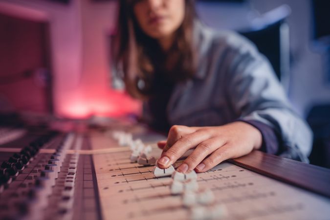 Woman hands mixing audio in recording studio