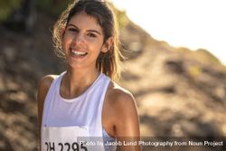 Female runner competing in mountain trail race 5wN710