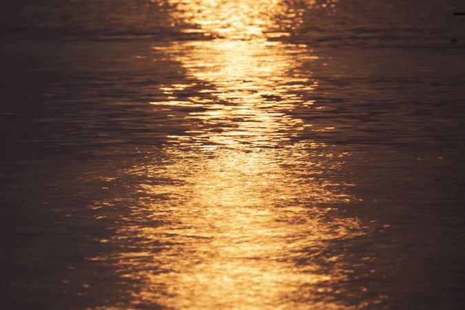 Sunset reflected on the uneven surface of the water, on the island of Koh Chang, Gulf of Thailand