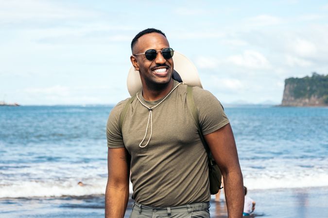 Black man wearing sunglasses in the beach