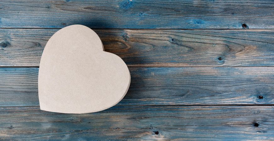 Valentine’s day heart shaped giftbox on faded blue wooden planks