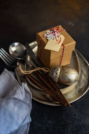 Christmas table setting with silver ware and gift box