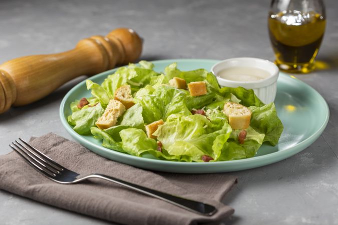 Caesar salad with croutons and bacon.