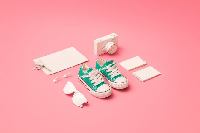 Back to school supplies with pink sneakers on pink background