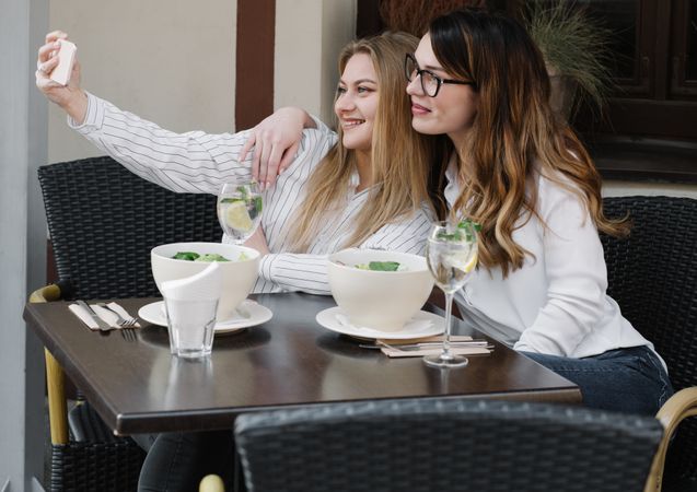 Young women taking selfie in restaurant