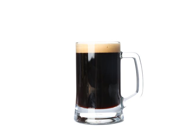 Glass of beer isolated on studio background