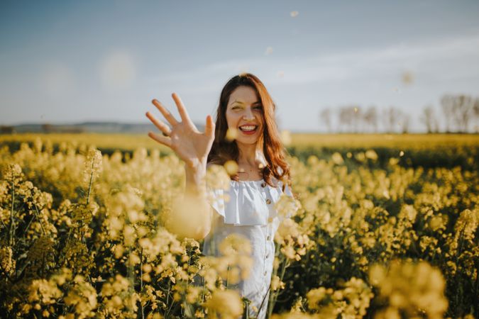Woman with flowers in field