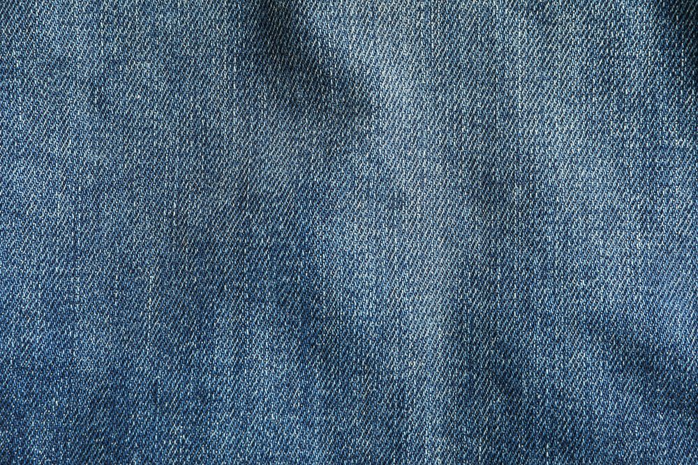 Texture of blue jeans as background, space for text