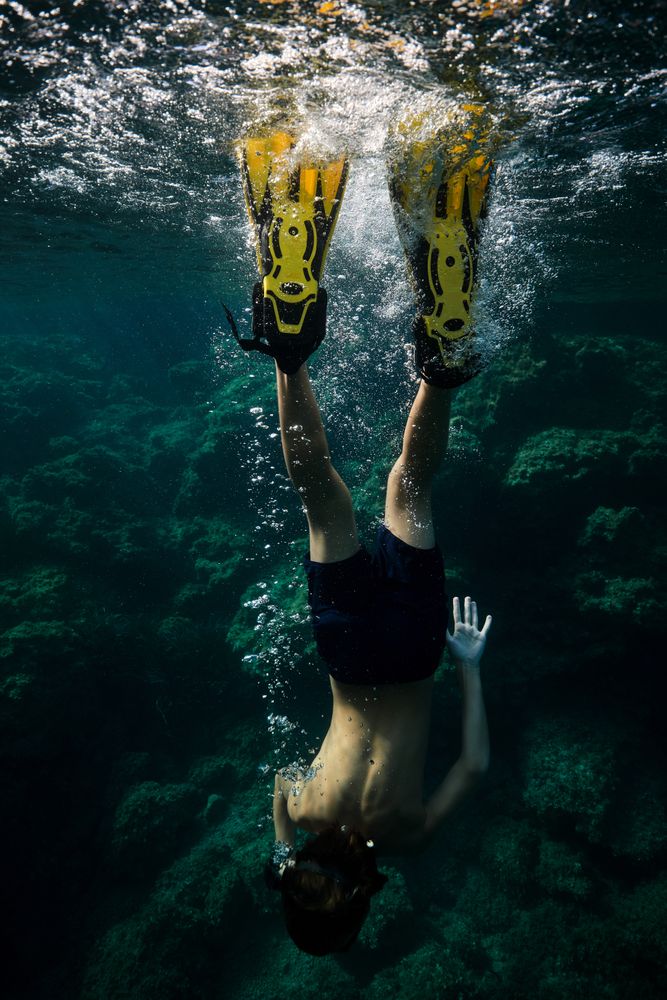Unrecognizable man plunging into seawater
