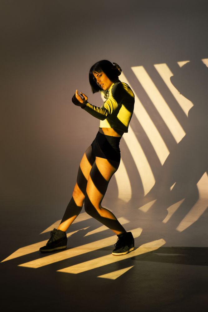 Sensual woman dancing under bright light