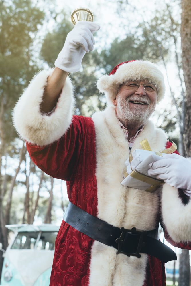 Santa Claus with gift and bell