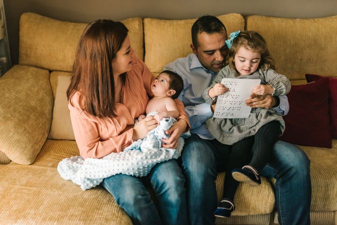 Happy family sitting on couch together