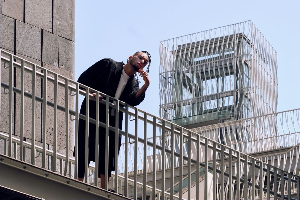 Black male standing on bridge