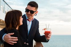 Young man and woman drinking juice from one glass