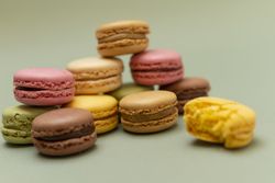 Colored delicious macaroons with a green background