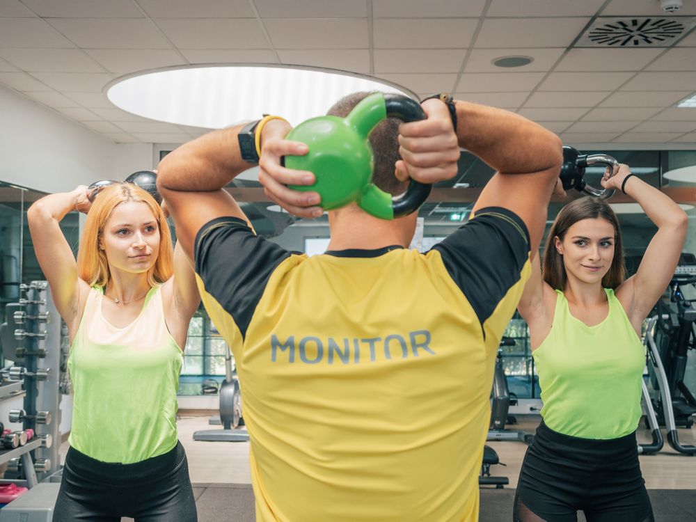 Athletes squatting with kettlebells