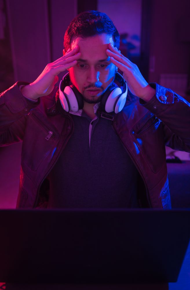 Man listening cheerfully to music with headphones.