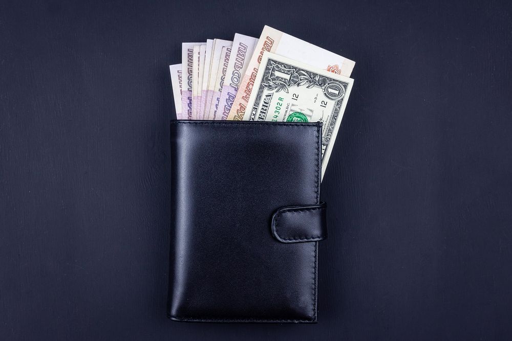 Different currencies in leather wallet