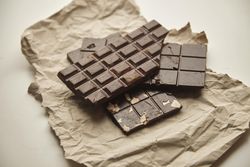 Stack of three chocolate bars on paper