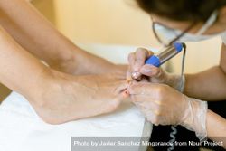 Nail varnish being removed from female feet in professional salon bYxJN4