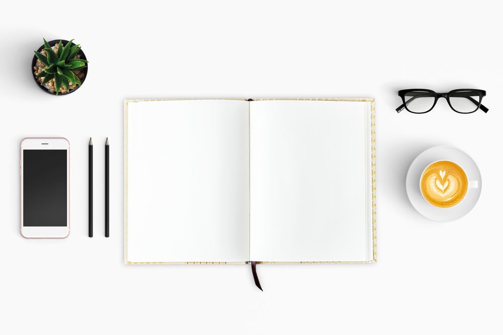 Modern workspace with coffee cup, smartphone, paper, notebook, tablet copy space